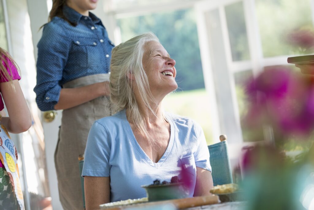 Woman seated at a table smiling